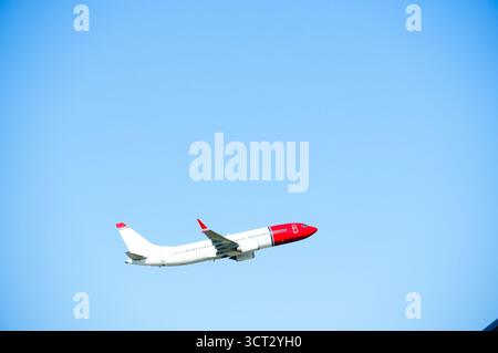 Airplane in the blue sky. Large airplane during takeoff. Stock Photo