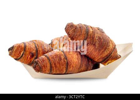 Chocolate croissants arranged on tray made of wood sheets isolated on white with clipping path included Stock Photo