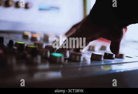 The hand on the button. Pressing the buttons on the remote control. Stock Photo