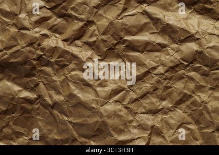 Crumpled Brown Craft Paper Texture with Folds and Wrinkles Stock Photo