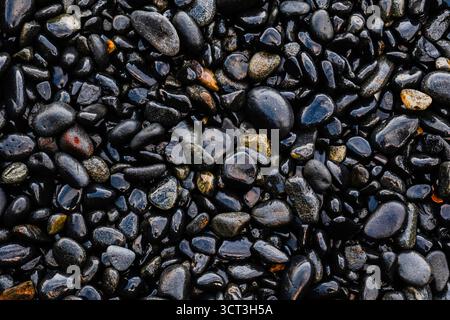 A material made of small wet pebbles on a Breton beach Stock Photo