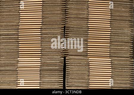 A stack of packaging cardboard folded and piled up in a storage shed Stock Photo