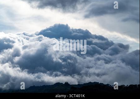 PÉREZ ZELEDÓN, SAN JOSÉ PROVINCE, COSTA RICA: Storm clouds gather over a ridge in the mountain rainforest of Pérez Zeledón, Costa Rica. Stock Photo