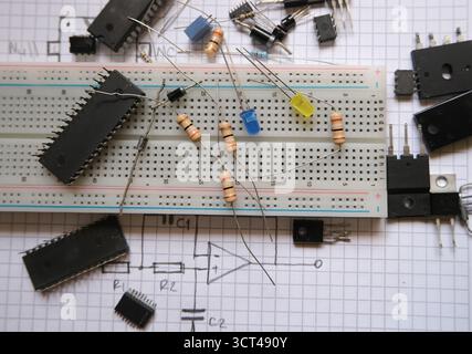 Electronic components in laboratory. Analog integrated circuits, resistors, LEDs on a breadboard. Stock Photo