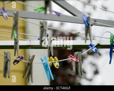 Old and New Clothespins Mixed on Drying Rack in Backyard Stock Photo