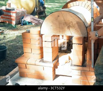 A man builds a brick wall. Brick put on the solution. Construction of a brick house. Stock Photo