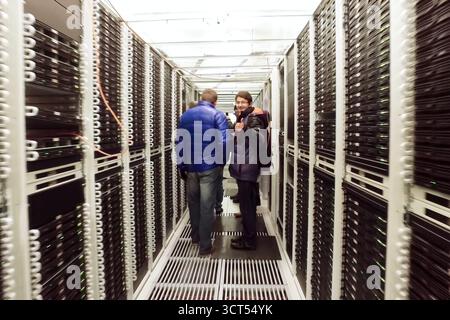 Arkhangelsk, Russia - December 27, 2017: System administrators in the corridor are the data center. Stock Photo