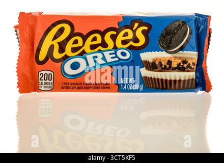 Winneconne, WI - 27 September 2025: A package of Reeses oreo milk chocolate white creme peanut butter cups with oreo cookie crumbs on an isolated back Stock Photo