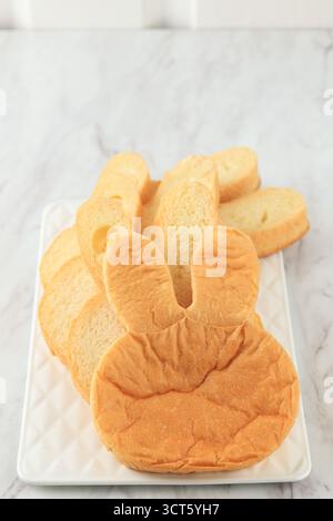 Bunny Shaped Hokkaido Soft Bread on White Plate Stock Photo