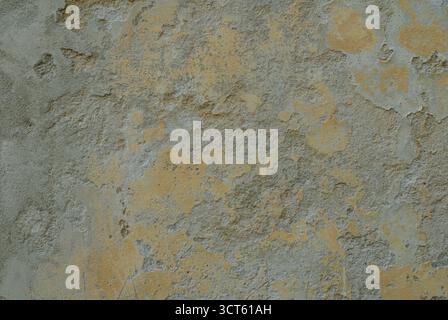 Detailed CloseUp Macro Texture of Aged Plaster Wall with Subtle Yellow and Gray Mottled Patches Evoking Rustic Charm and Weathered Character Stock Photo