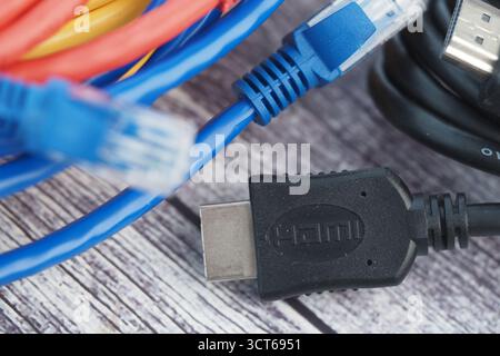 Cables and connectors on wooden table for digital devices Stock Photo