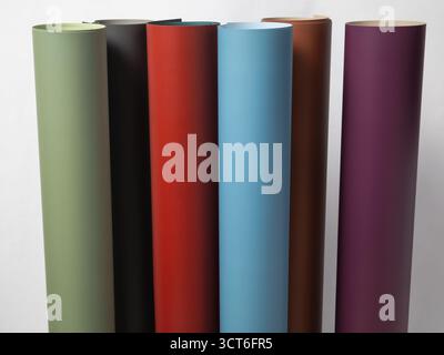 seven rolled seamless paper backdrops in diverse matte colors, ready for studio photography, perfect for creative projects and product shots Stock Photo