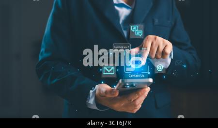Business professional using smartphone with AI chatbot contact us icon, futuristic digital communication, online customer service, virtual assistant t Stock Photo