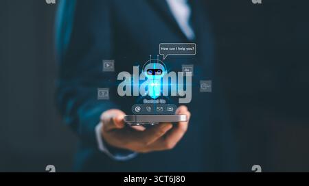 Business professional holding smartphone with AI chatbot contact us hologram icon, futuristic digital customer support, virtual assistant technology, Stock Photo