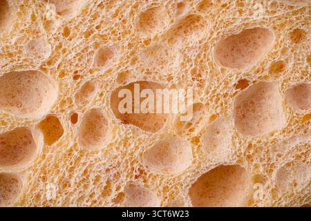 Macro view of yellow cleaning and dishwashing sponge texture Stock Photo