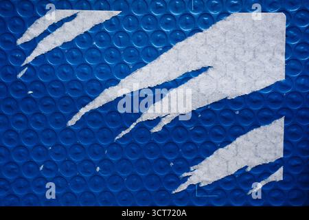 Blue bubble wrap package with aggressively peeled paper label sticker texture Stock Photo