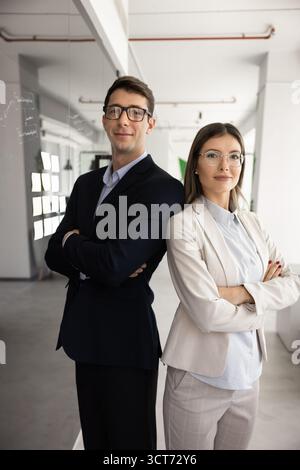 Two young successful business professionals standing together Stock Photo
