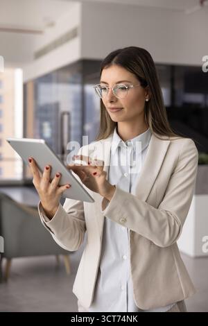 Young female business expert woman using gadget for work communication Stock Photo