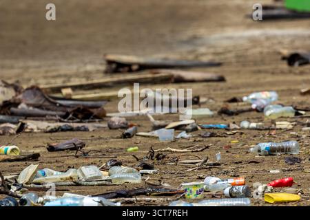 Plastic bottles and other rubbish washed up by the tide on a beach in Borneo Stock Photo