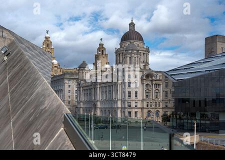 Liverpool, Merseyside, UK, 07 September 2025: Historical architecture merged with modern structures under cloudy skies. Stock Photo
