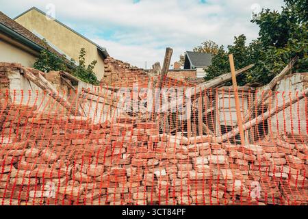 Heap of weathered bricks at house demolition site, construction waste concept. Selective focus. Stock Photo