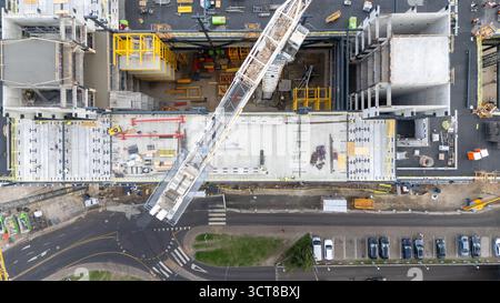Aerial view of a construction site with cranes and building structures. Stock Photo
