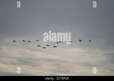 Formation of military aircraft flying in diamond pattern against cloudy sky Stock Photo