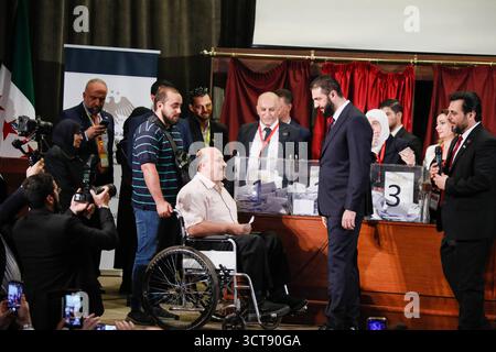 Syria Holds First Parliamentary Elections Since Assads Fall Damascus, Syria October 5, 2025: Syrian President Ahmed al-Sharaa meets a voter with a disability at a polling station during Syrias first parliamentary elections since the fall of the Assad regime. Damascus Syria Copyright: xMohammadxBashirxAldaherx Stock Photo