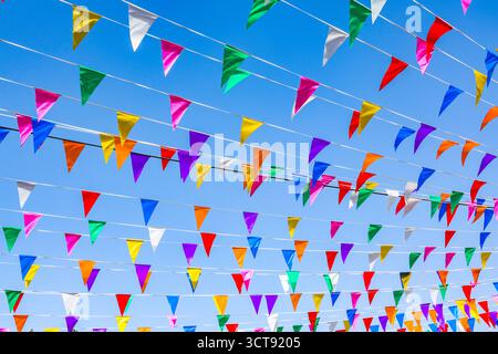 Multi colored party flags against the blue sky Stock Photo