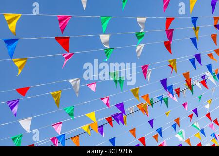 Multi colored party flags against the blue sky Stock Photo