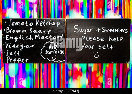 A restaurant offers condiments and sweeteners for customers to self-serve, ensuring they have what they need to enjoy their meal. Stock Photo