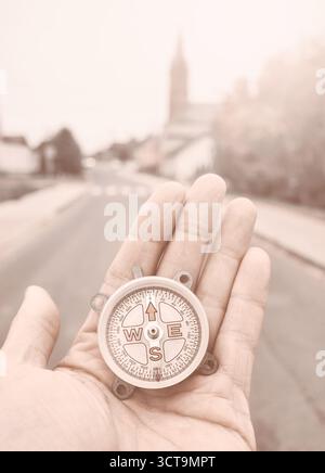 A compass in hand, conceptual photo, selective focus, color toning applied. Stock Photo