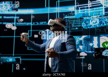 Portrait of a young african american engineer focused on VR headset programming and analytics, surrounded by neural networks systems and AI data visualization. Future of innovation in tech. Stock Photo