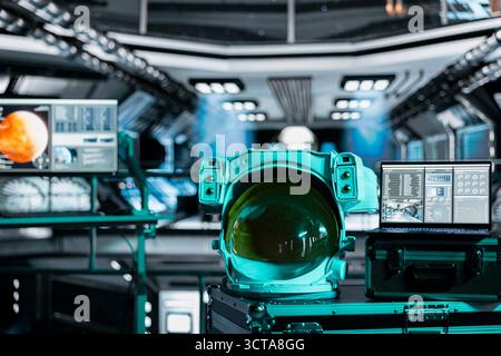 Close up of astronaut gear next to laptop in spaceship displaying planetary scan of Mars during expedition. Notebook in spacecraft showing red planet surface analytics metrics during orbital voyage Stock Photo