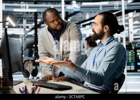 Data center engineering team working together to verify neural network parameters. Server hub teamworking colleagues inspecting configurations to ensure optimal performance Stock Photo