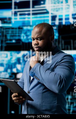 Black smart IT engineer examining artificial intelligence brain systems using cloud computing tools and advanced programming. Using machine learning for virtual assistant automation. Stock Photo