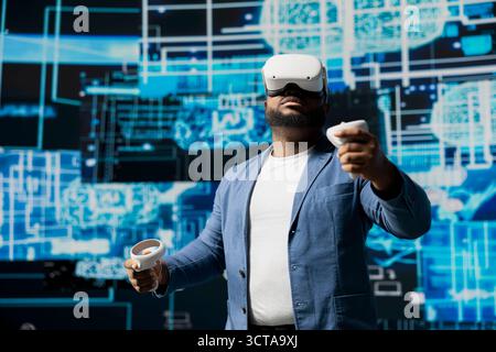 Black businessman using advanced technology VR headset tools to explore data science, automation and AI ethics in a digital data processing environment. Works on machine learning. Stock Photo