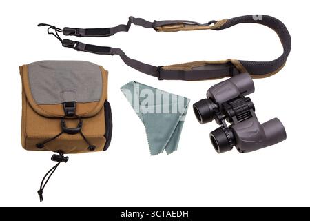 Binoculars with a carrying case, strap, and cleaning cloth, isolated on a white background. Stock Photo