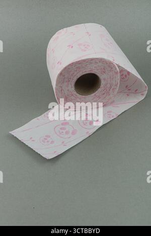 A roll of toilet paper with cute pink panda designs is positioned on a subtle gray background. The paper is partially unrolled, showcasing the playful Stock Photo