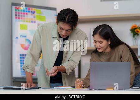 Engaging Teamwork. Young professionals collaborating on project in bright office. Stock Photo