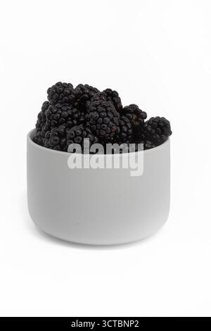 Fresh raw blackberries in white pot isolated on white background Stock Photo
