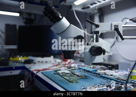 An advanced microscope in the electronics lab for detailed circuit board analysis Stock Photo