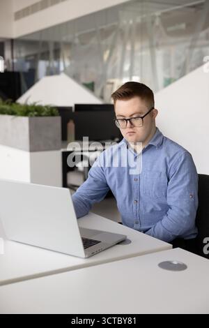 Serious Caucasian employee man having Down syndrome Stock Photo