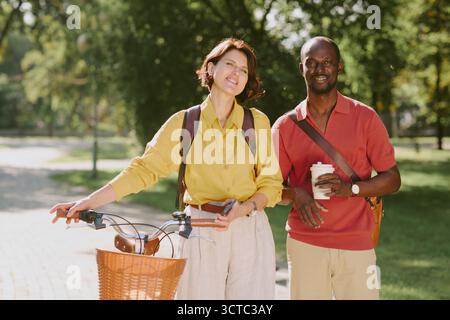 Young Caucasian Woman and Young Black Man Standing Outdoors Smiling Together Stock Photo