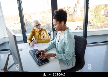 Artificial intelligence and technology development team using laptops, coding and smart solutions Stock Photo