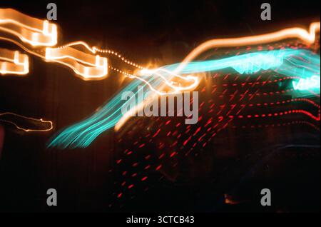 Abstract motion blur of neon lights in vibrant colors at night Stock Photo