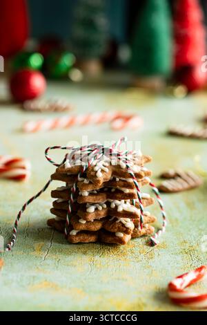 Festive stack of tree-shaped gingerbread cookies tied with string Stock Photo