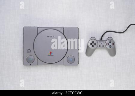 Top shot of a Playstation 1 with controller on a white Resopal board Stock Photo
