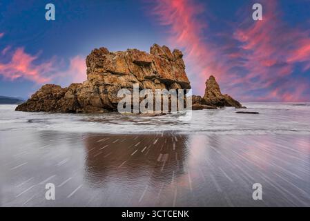 Sunset Blaze over Sea Rocks Stock Photo