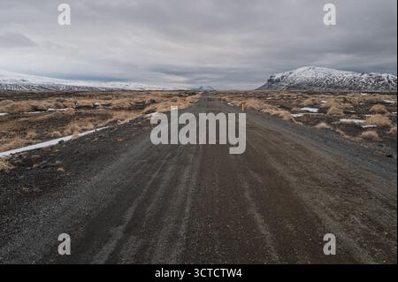 Gravel country road in Iceland—rural two-lane through farms and coast; seasonal scenery year-round (not an F-road or Highland route) Stock Photo